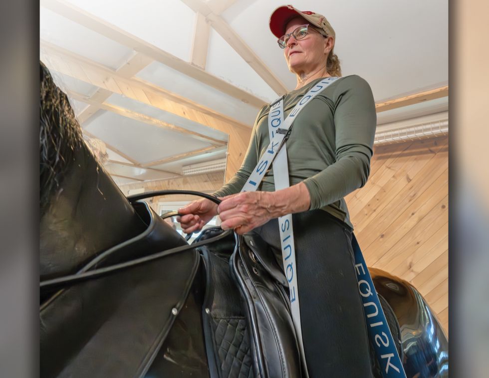 Rider using Equisk resistance bands on RooElla horse simulator to improve stability, posture, and equestrian biomechanics.